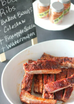 plate of ribs, cooked and cripsy on a table with spice rub, decorative