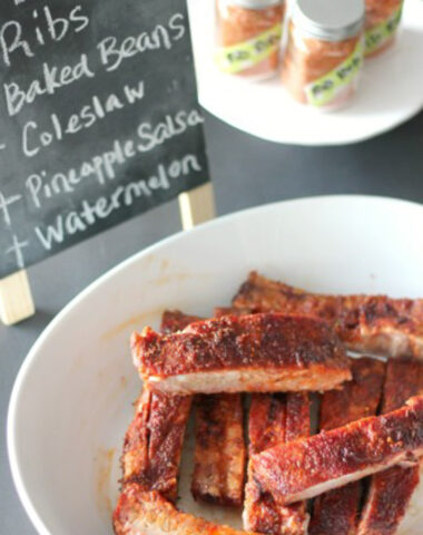 plate of ribs, cooked and cripsy on a table with spice rub, decorative