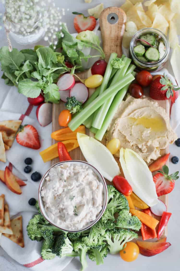 Summer Crudite Snack Board. Raw and fresh summer veggies, paired with your favorite dip is anything but boring - A Summer Crudité board is the perfect beginning to any weekend bbq!