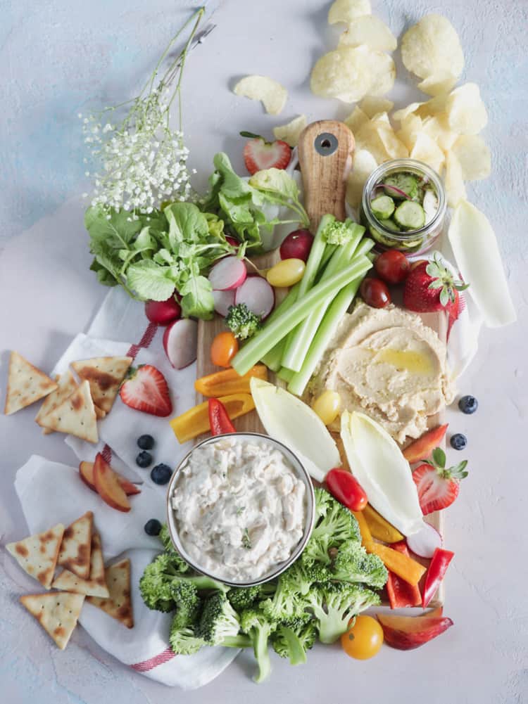 Summer Crudite Snack Board. Raw and fresh summer veggies, paired with your favorite dip is anything but boring - A Summer Crudité board is the perfect beginning to any weekend bbq!