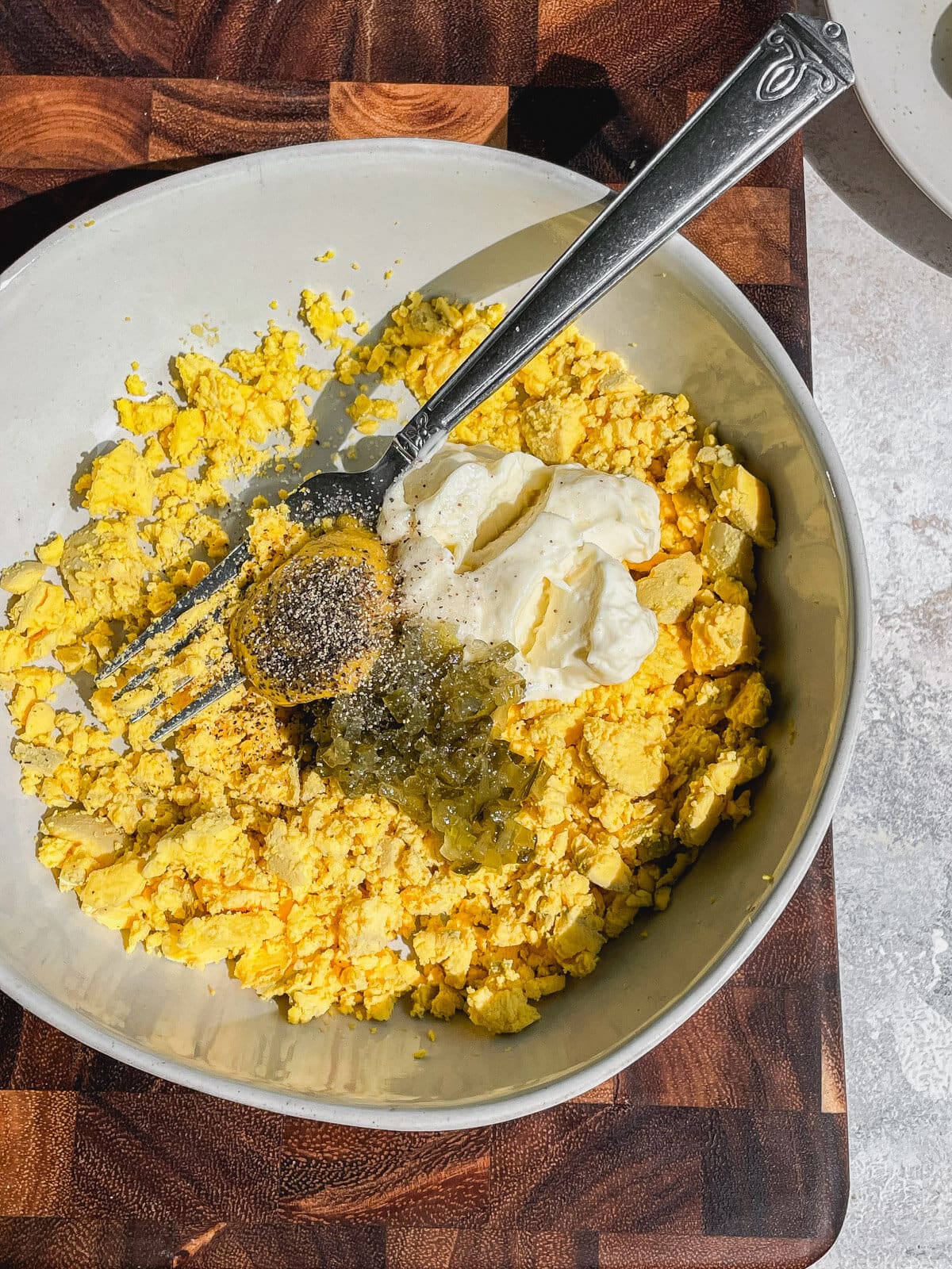 bowl of yolk mixture with ingredients: yolks, mayo, mustard, relish, pickle juice