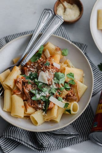 Instant Pot Pulled Pork Ragu over rigatoni noodles in a white bowl