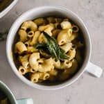 mac and cheese cooked and served in an aqua color bowl