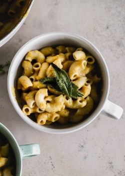 mac and cheese cooked and served in an aqua color bowl