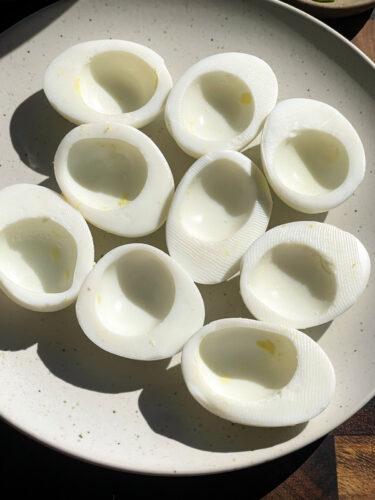 sliced eggs, yolks removed to prepare deviled eggs
