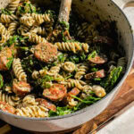 fusilli pasta with store bought pesto with arugula and chicken sausage in a white pot