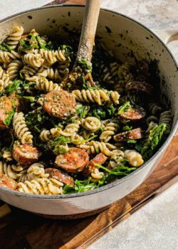 fusilli pasta with store bought pesto with arugula and chicken sausage in a white pot