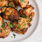 Chicken thighs on a plate with parsley.